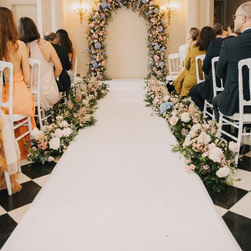 Wedding ceremony aisle with floral arrangements